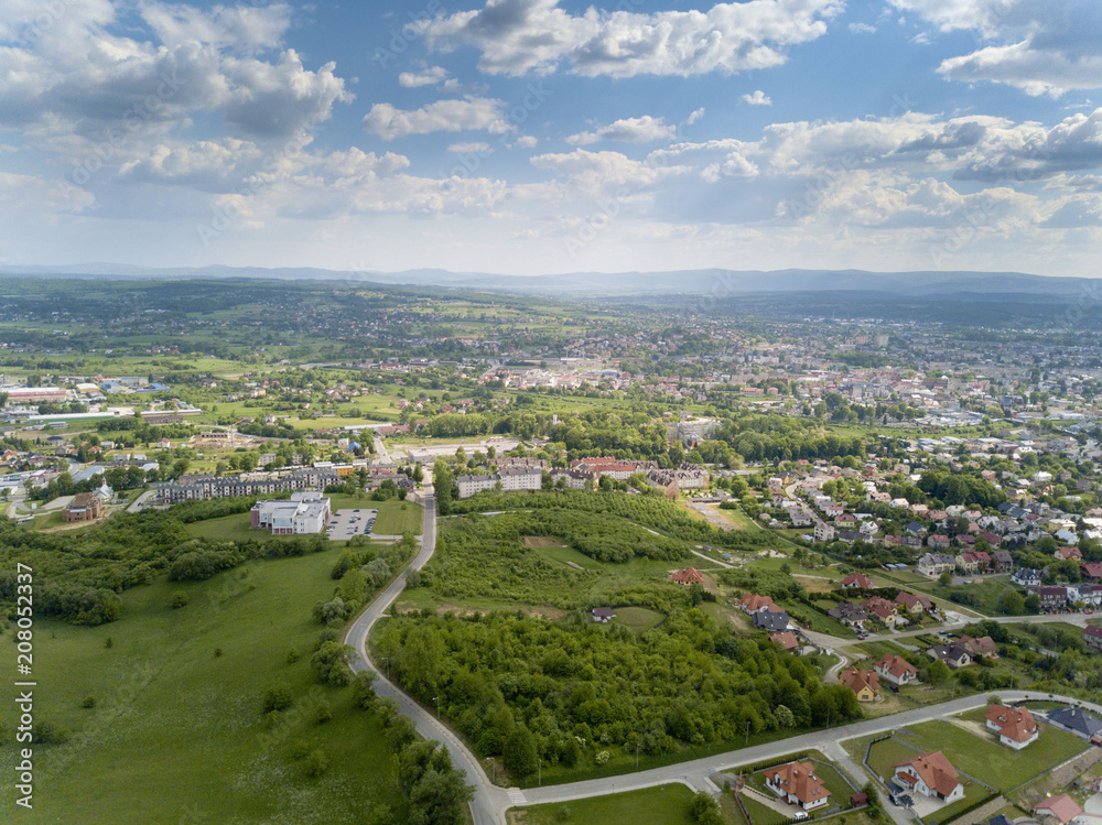 Panorama from a bird's eye view. Central Europe: The Polish town of Jaslo is located among the green hills. Temperate climate. Flight drones or quadrocopter.