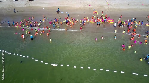 children gambol in ocean water and on beach