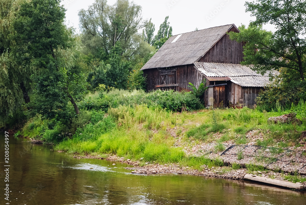 Old wooden barn over Liwiec River in Masovian Voivodeship of Poland Old wooden barn over Liwiec River in Masovian Voivodeship of Poland