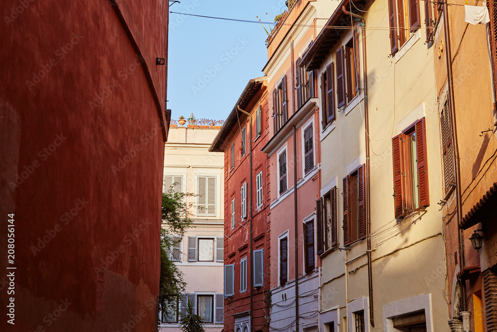 Beautiful buildings standing on narrow street on sunny day in Rome, Italy