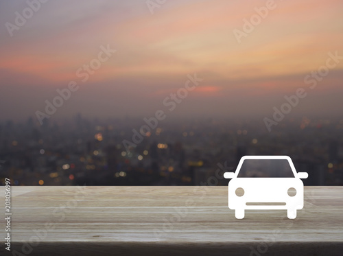 Taxi car flat icon on wooden table over blur of cityscape on warm light sundown  Business service car concept