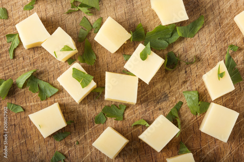 Cubes of fresh cheese with green parsley leaves