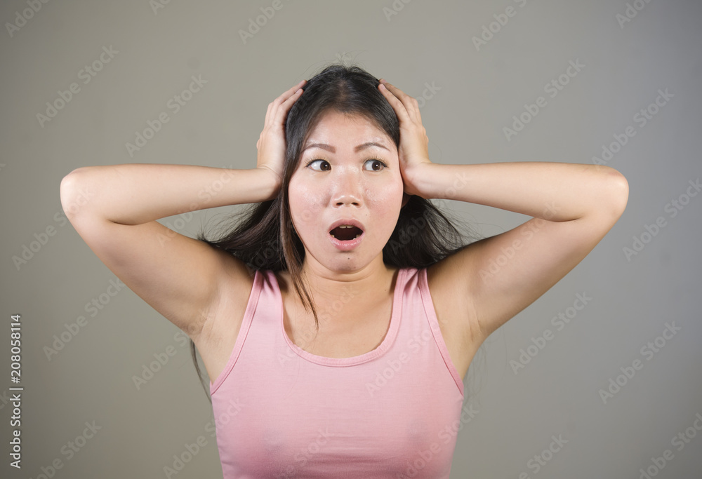young sweet and beautiful Asian Korean woman gesturing shocked and surprised as if oh my god what a disaster in astonished face expression young sweet and beautiful Asian Korean woman gesturing shocked and surprised as if oh my god what a disaster in astonished face expression