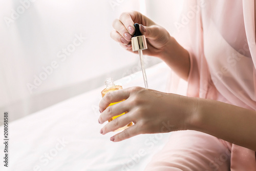 Woman Holding Cosmetic Oil