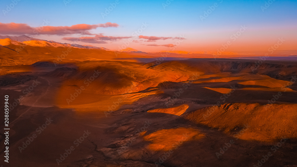 Red earth with iron oxides at sunset aerial view. Beautiful sunset. Martian landscape.