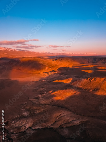 Red earth with iron oxides at sunset aerial view. Beautiful sunset. Martian landscape.