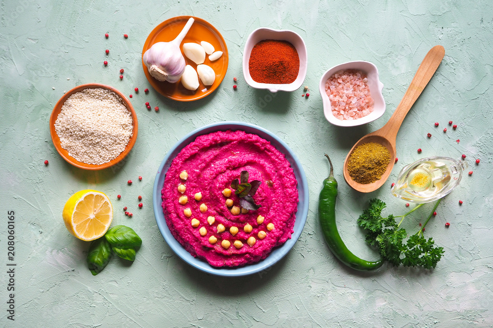 Hummus with beets on the table and ingredients for traditional hummus. Hummus with beets on the table and ingredients for traditional hummus.