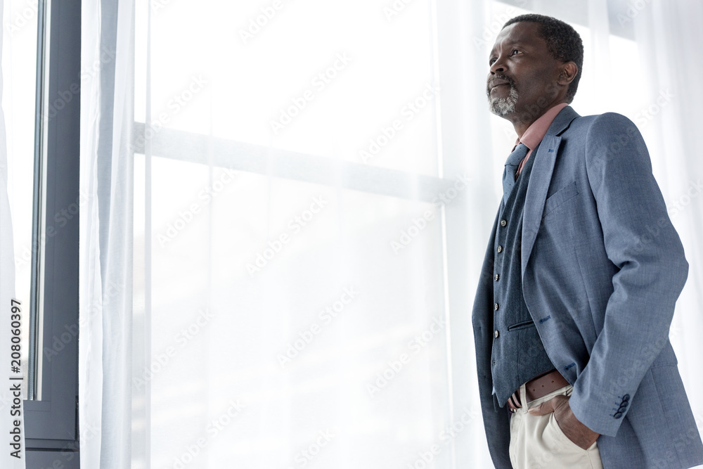 handsome mature african american man posing in blue jacket