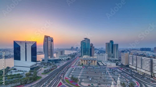 Dubai creek landscape at sunset timelapse with boats and ship near waterfront photo