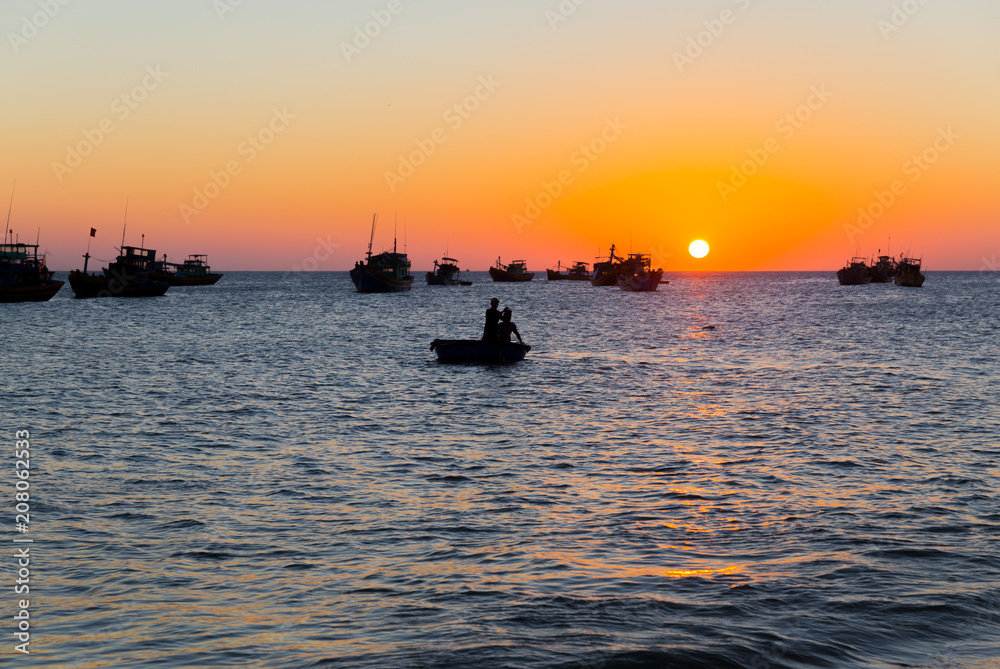 Vietnam Mui Ne village fishing boats and ships in evening sunset light
