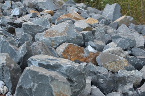 Pile of large irregular rock used as fill for a railroad grade