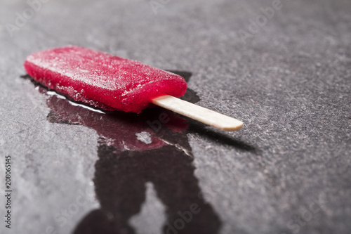 Dropped Ice Lolly (Popsicle) on pavement in summer heat