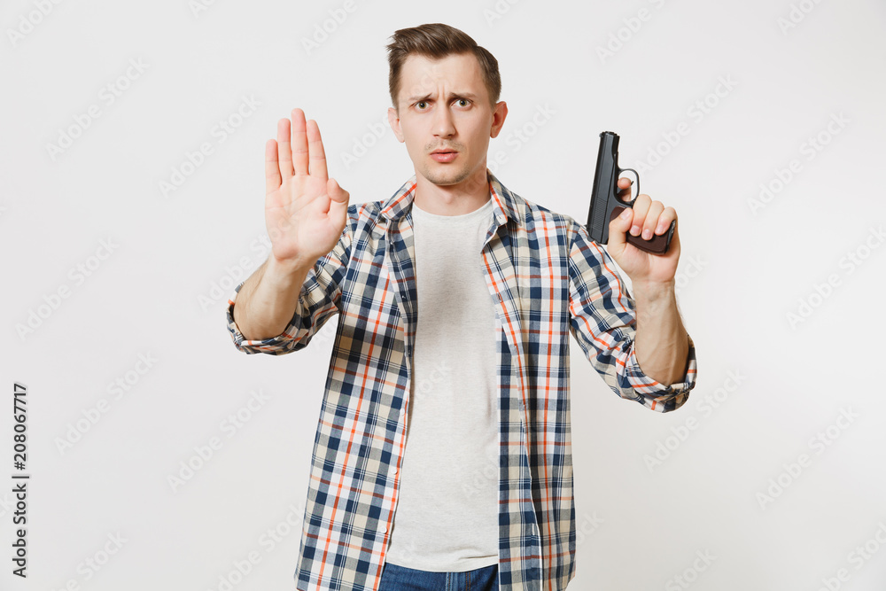 Man with gun in hand showing stop gesture with palm isolated on white background. Male hand no shooting symbol. Stop violence, weapons in school control, no killing people children, problem concept. Man with gun in hand showing stop gesture with palm isolated on white background. Male hand no shooting symbol. Stop violence, weapons in school control, no killing people children, problem concept.