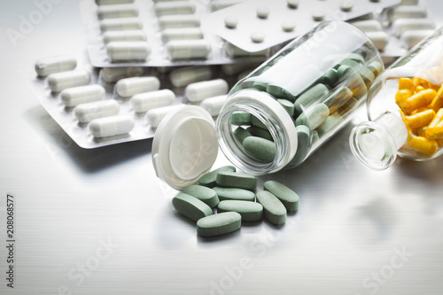 Different medicines on a gray metal table as a symbol of the pharmaceutical industry photo