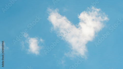 Cloud in a heart shape on a blue background. © supaleka