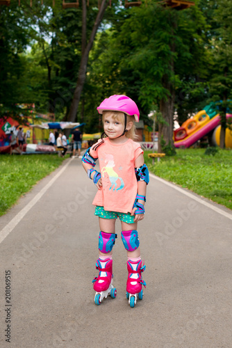 5 years old girl skating on roller skates in park