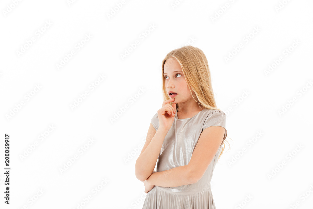 Pensive young blonde girl in dress touching her chin Pensive young blonde girl in dress touching her chin