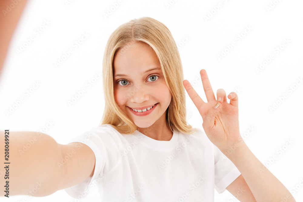 Smiling young blonde girl in casual clothes making selfie Smiling young blonde girl in casual clothes making selfie