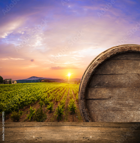 Red wine with barrel on vineyard in green Tuscany  Italy