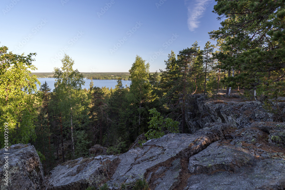 Lake, lush forest and cliff viewed from the Pirunvuori (