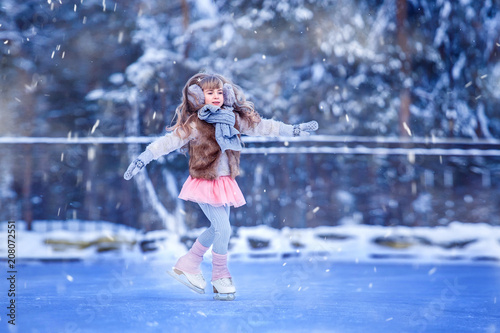 A girl, a figure skater is skating in a park on ice