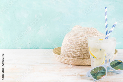 Fototapeta Naklejka Na Ścianę i Meble -  Summer holidays vacation concept background, hat, sunglasses, iced drink (lemonade, mojito), white wooden background copy space