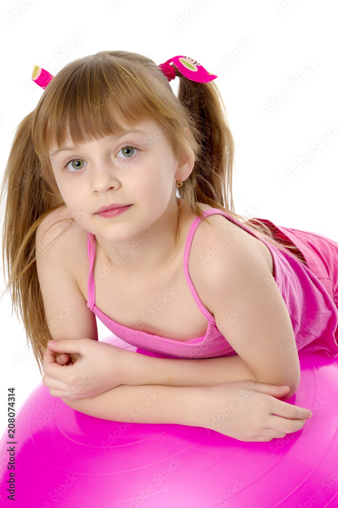 little girl doing exercises on a big ball for fitness. little girl doing exercises on a big ball for fitness.