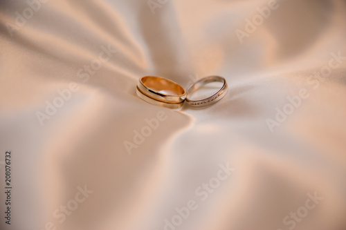 wedding gold rings on a shiny fabric