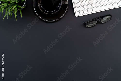 Flat lay of top view modern black desk work table with computer laptop and stationary in home office includes copyspace for add text or graphic