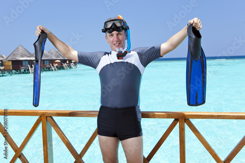 Принти на полотні sports man with flippers, mask and tube on sundeck of a house over the sea