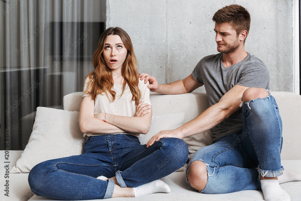 Man trying to talk to his bored girlfriend Man trying to talk to his bored girlfriend