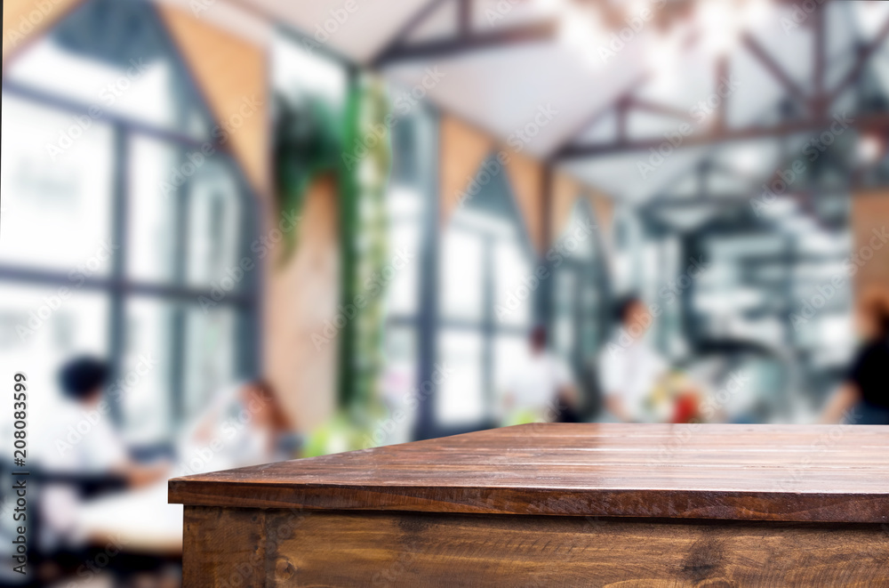 Selected focus empty brown wooden table and Coffee shop blur background with bokeh image. for your photomontage or product display Selected focus empty brown wooden table and Coffee shop blur background with bokeh image. for your photomontage or product display