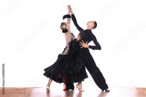 Latino dancers in ballroom against white background