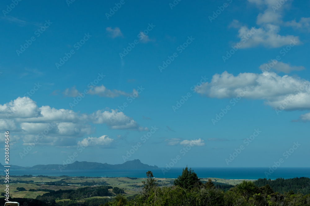 Northland New Zealand view of ocean and mountains over paddocks