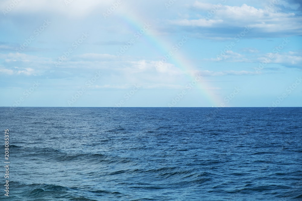 rainbow in the sky, above the ocean