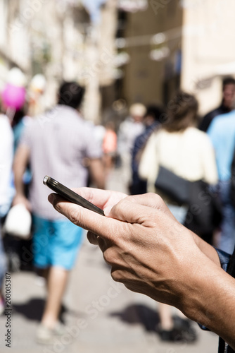man using a smartphone in the street.