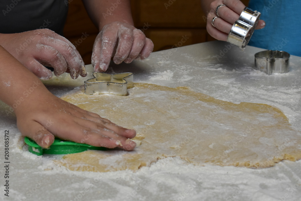 baking hands cutting out cookies