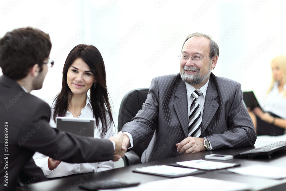 handshake between colleagues in the workplace in the office handshake between colleagues in the workplace in the office