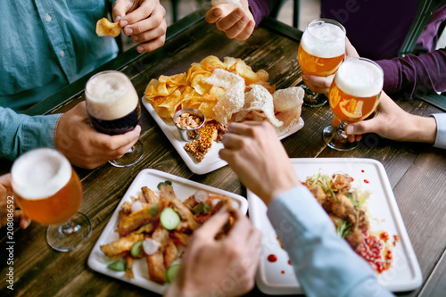 Men Drinking Beer And Eating Food Closeup