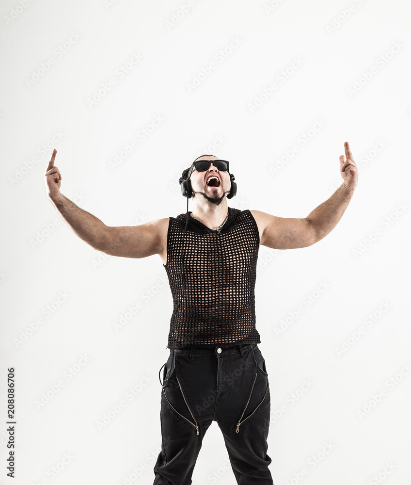 Naklejka premium emotional and charismatic DJ - rapper with headphones on a light