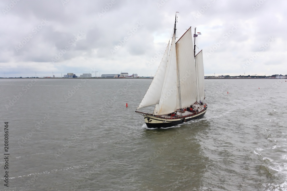 Sailing ship on the Wadden Sea, leaving the port of Harlingen in the Netherlands