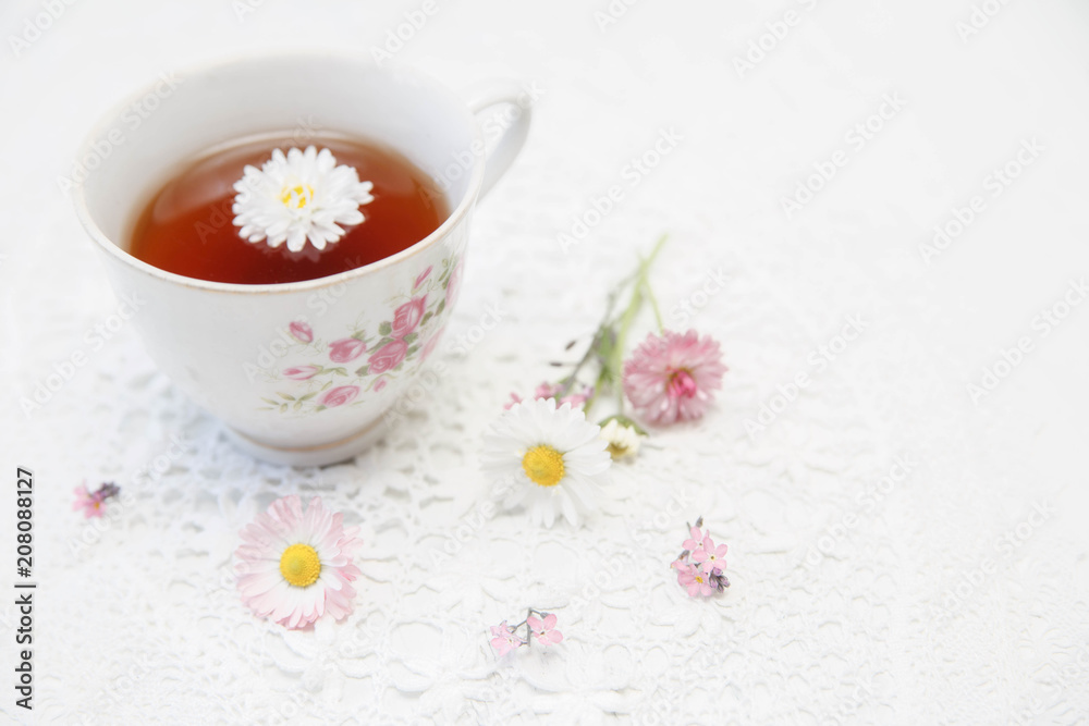 Cup of tea with daisies on white background Cup of tea with daisies on white background