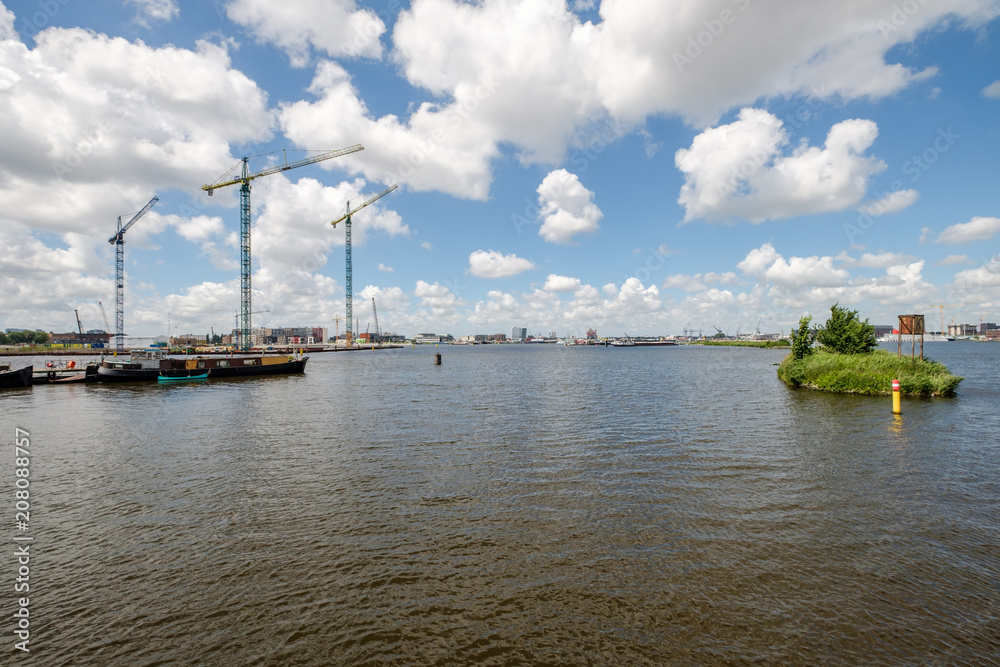 Start of the construction of new appartments at the side of het IJ, seen from the Silodam Amsterdam, the Netherlands Start of the construction of new appartments at the side of het IJ, seen from the Silodam Amsterdam, the Netherlands