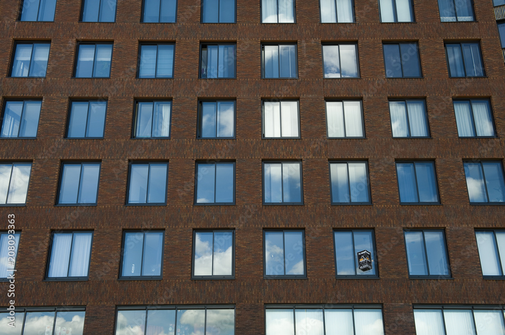 Cloud reflected in apartment block windows