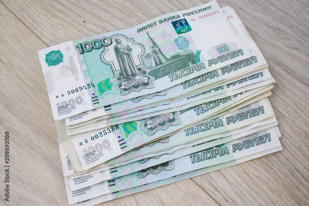 business, finance, saving, banking concept - close up bundle of money Russian Banknotes thousand rubles on wooden table business, finance, saving, banking concept - close up bundle of money Russian Banknotes thousand rubles on wooden table