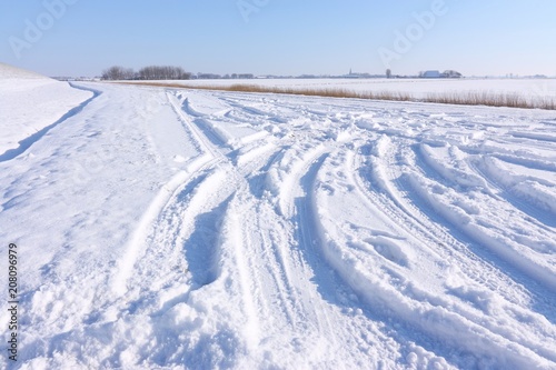 Car tracks in the snow in winter landscape