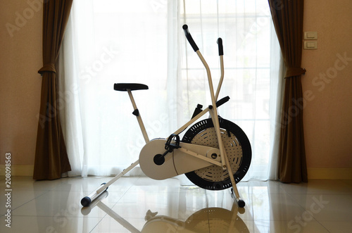 Empty exercise bike in living room of modern house