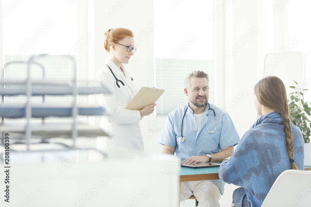 Friendly gynecologist talking with patient