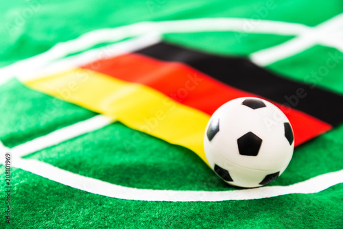 German flag and soccer ball on green grass field