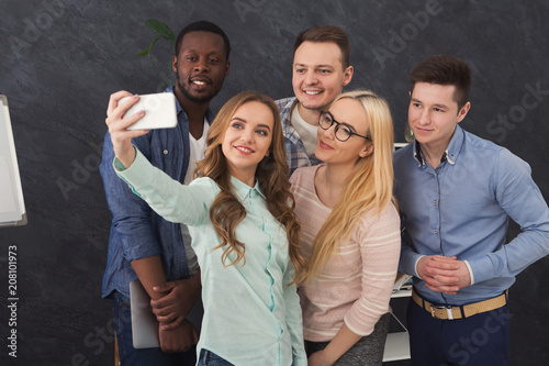 Business people making group selfie, having fun